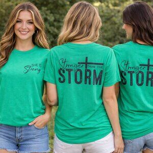 She Is Strong, Stronger Than The Storm | Graphic T-Shirt